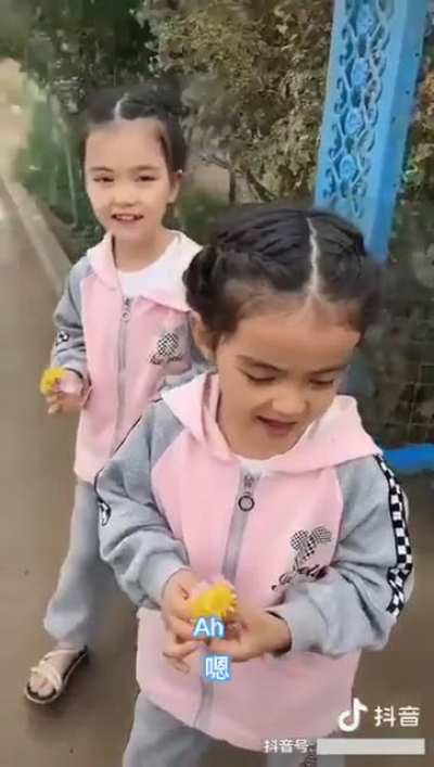 The two Uyghur twins stood by the roadside every day with flowers, waiting for their father to return from "school."