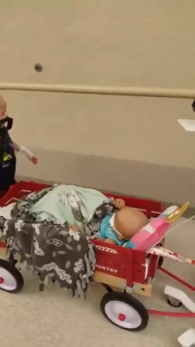 He takes his little buddy on a ride in his &ldquo;Radio Flyer&rdquo; wagon