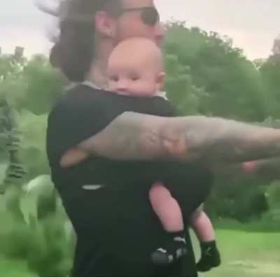 This parent with his infant child on a bike.