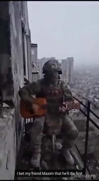 RU POV: "Just Don't Tell Mother I'm In Bakhmut" Performed by a Russian soldier in a ruined Bakhmut while shelling and gunfire can be heard