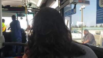 Woman on bus will not give a seat to a disabled man in a wheelchair.