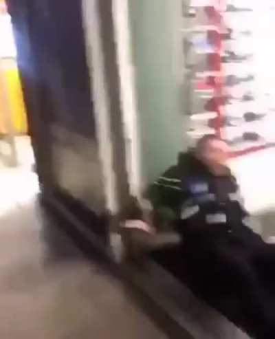 A police officer attempted to physically move a man, but the man resisted by slamming the officer into the wall.