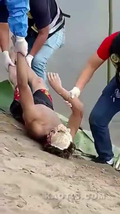 Body with exposed skull pulled from the water 