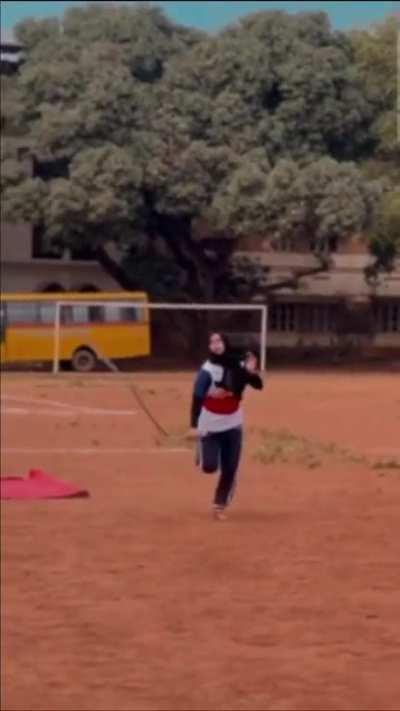 Kalaripayattu demonstration with a Urumi: whip sword by a high school girl in Kerala, India.