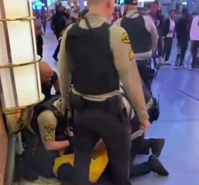 Young man tries a flying switch knee on a Las vegas cop.