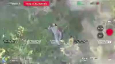 A wounded Ukrainian soldier is observed by a Russian drone. Eventually, a drone arrives and strikes the position