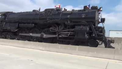 Steam powered locomotive (Santa Fe 3751) absolutely smokin it down highway in California