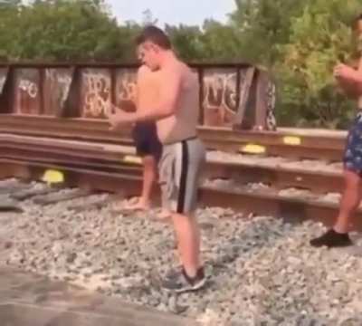 Guy tries to run and jump into a river but doesn&rsquo;t see the boat until after he jumps, even though his friends try to warn him.
