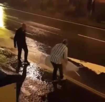This old couple out in the rain