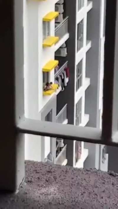 Toddlers playing on 17th-floor window ledge