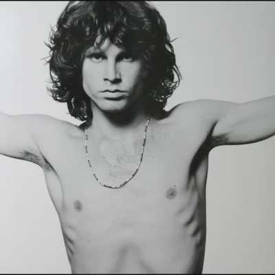 "The Doors" by Oliver Stone (1991), starring Val Kilmer, and the actual Jim Morrison during the "The Young Lion" photoshoot in 1967.