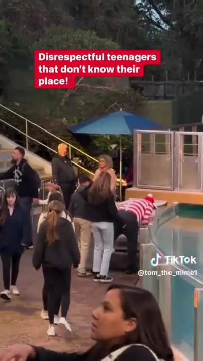 Group of main characters interrupt a performer&rsquo;s act