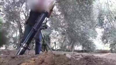 Hamas member launching mortar towards Israel in civilian clothing