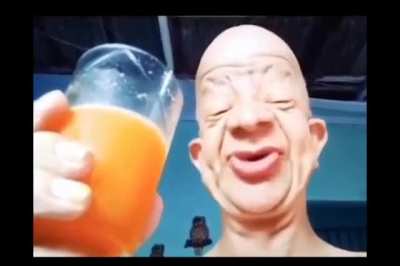 Funny man drinks orange juice