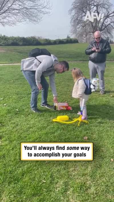 A girl trying to jump on a toy