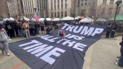 Woman fights with a banner, banner fights back