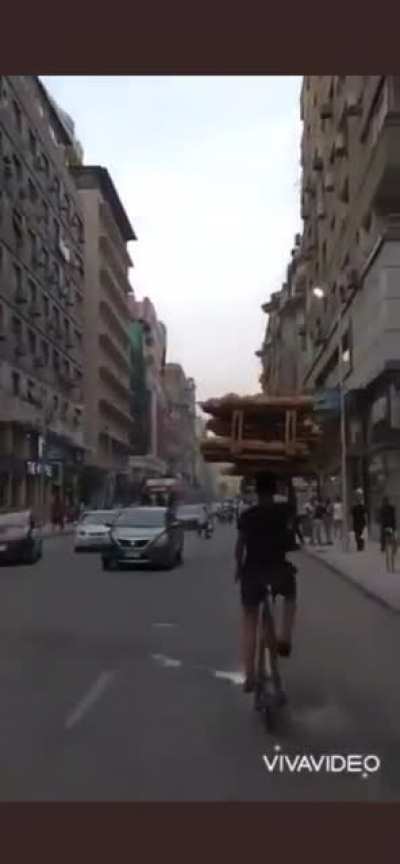 Filming the bread boy in middle of Cairo&rsquo;s traffic.