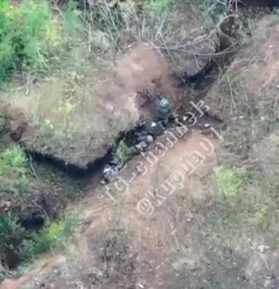 Ukrainian Soldier finishes a defeated Russian after a hand to hand engagement. (Drone POV)