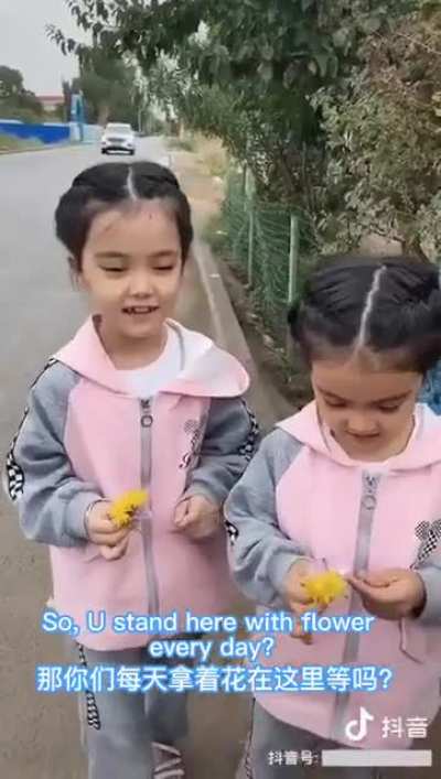 Two Uighur girls stood by the roadside every day with flowers, waiting for their father to return from re-education camp