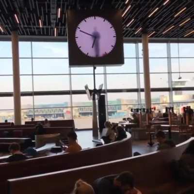 "Human Clock" in Amsterdam airport. 12 hour recording that is looped.