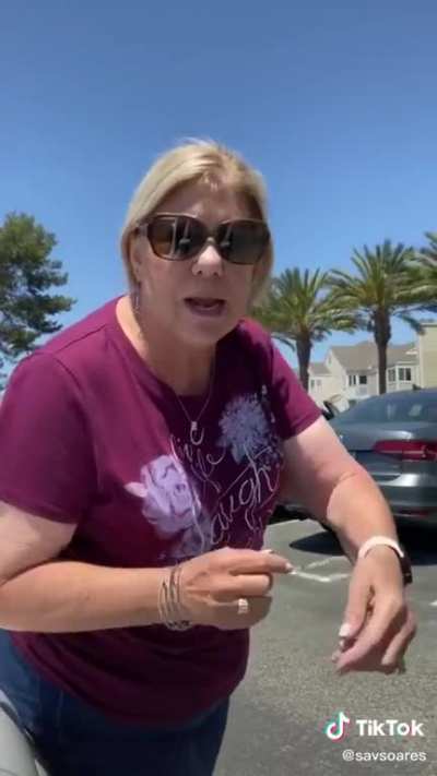 Karen sits on car to get the parking space