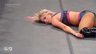 Alexa Bliss defeated, eyes rolling, helpless and exhausted on the floor