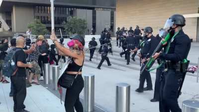 LAPD stand-off with protesters during a Portland Solidarity march on 7/25. One officer completely loses his cool and opens fire on unarmed protesters, using his shotgun at point blank range. This guy doesn&rsquo;t have the composure for this job.