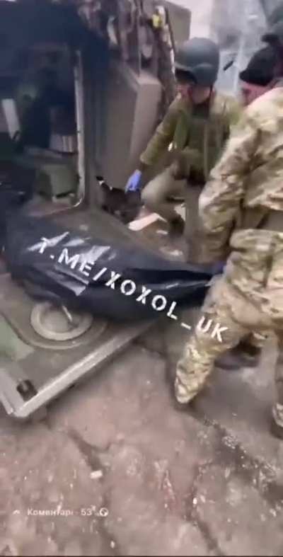 RU POV. Ukrainian soldiers unloading bodybags from an APC in Bakhmut