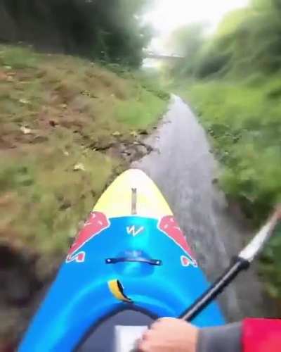 Guy does canoeing on a thin wet grass strip with insane control and precision