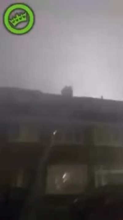 Guy launches firework in another open window.
