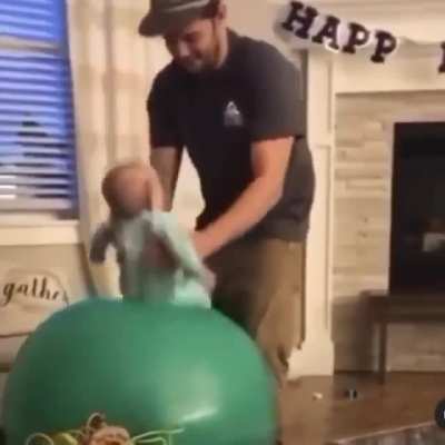 Baby sitting on space hopper