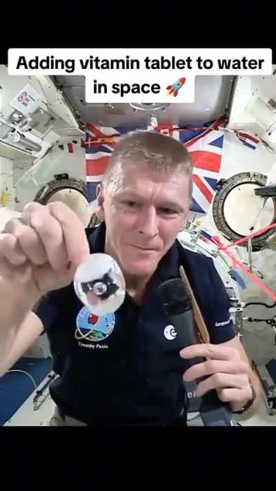 Astronaut drops fizzy tablet into floating water bubble on ISS