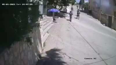 Bored Israeli soldier caught by security cameras throwing tear gas into a Palestinian house