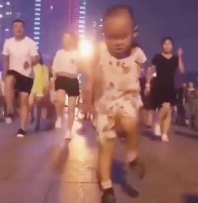 The cute boy imitates street dancers doing shuffles and dazzles with his talent.
