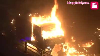 HK police armored truck was set on fire by students defending The Hong Kong Polytechnic University and was forced to retreat. (Credit: Appledaily)