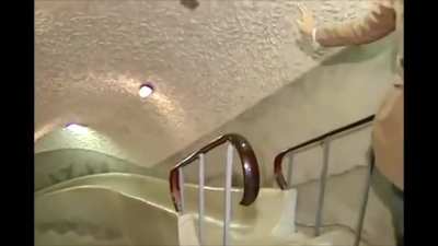 Asian reporter going down slide