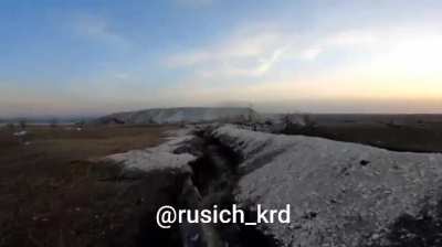 GoPro footage showing two Russian soldiers in the Bilohorivka area, they advance through a shallow trench until they have to retreat into a dugout where they hold out, Spring 2024 (no music)