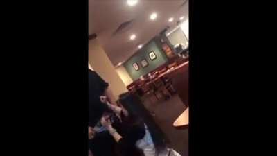 A waiter gets a blowjob inside of a restaurant