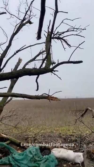 A Ukrainian soldier sitting in a tree fires an FGM-148 Javelin at Russian armoured vehicles. Spring 2023.