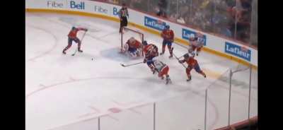 Slafkovsky makes makes a pass with his stick behind his back. 