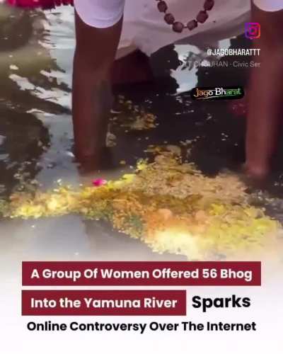 Woman puts food in the Yamuna