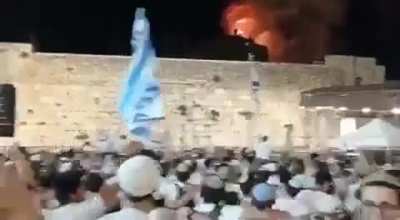 Israelis chanting and dancing while Jerusalem is being bombed in the background