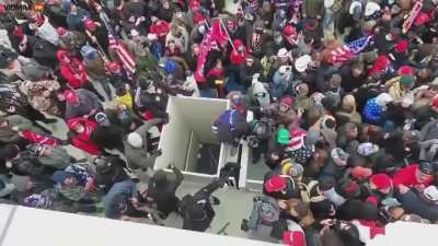 Trump supporters trying to stop Antifa from breaking into the Capital.