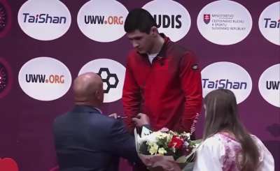 Angrily assigning a medal.