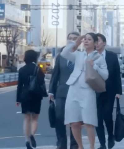 Woman faints on sidewalk.