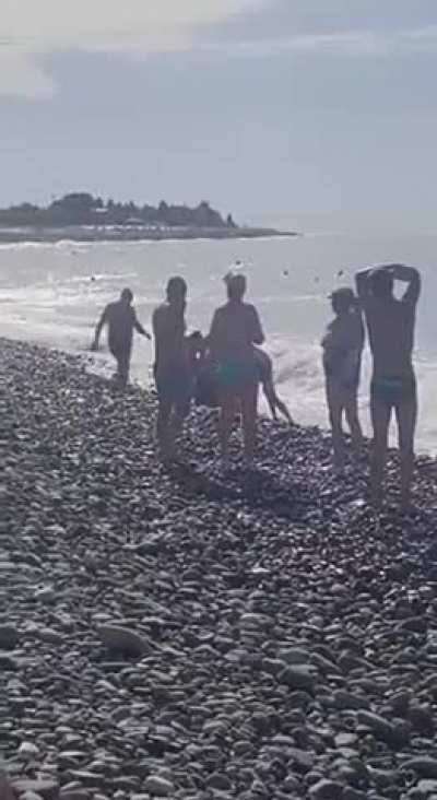 Sea mine washed up on a beach in Sochi - handled by potential Darwin award winners