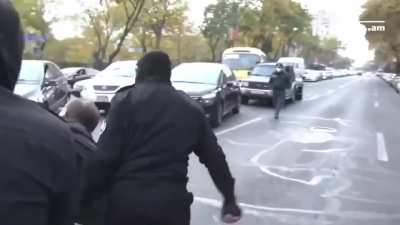 Man singing "I believe I can fly" while being carried by the cops