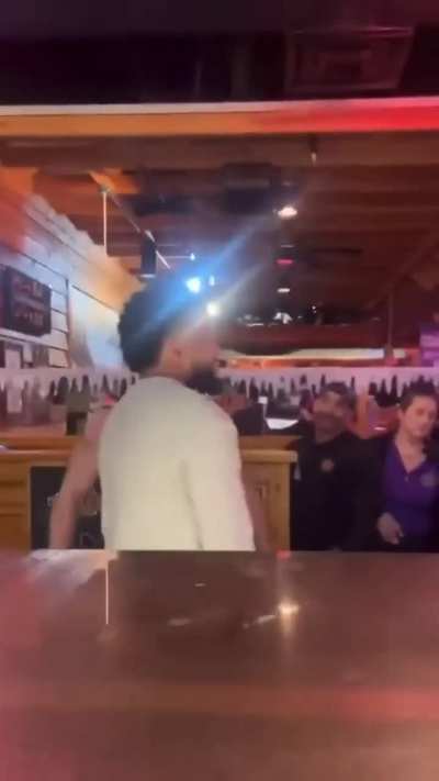 Man hissing and snarling in restaurant.