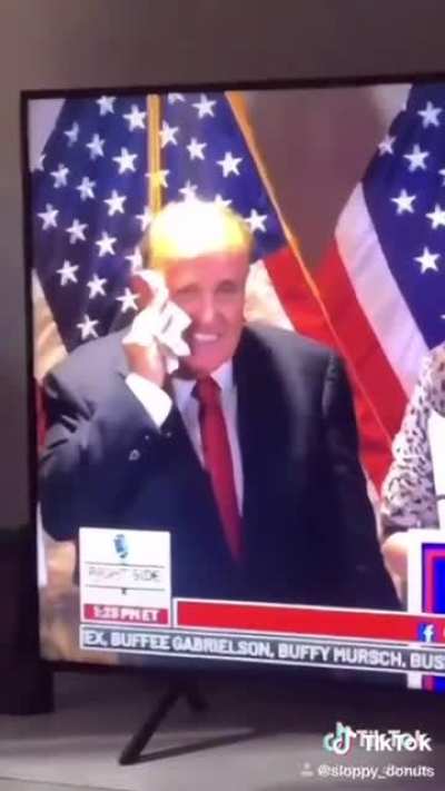 Rudy Giuliani smears snot all over his face