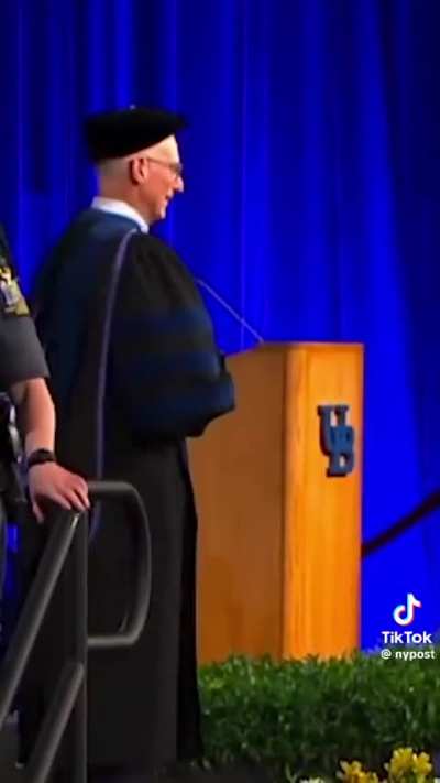 University of Buffalo graduate was chased off stage by police for having his infant son on stage with him